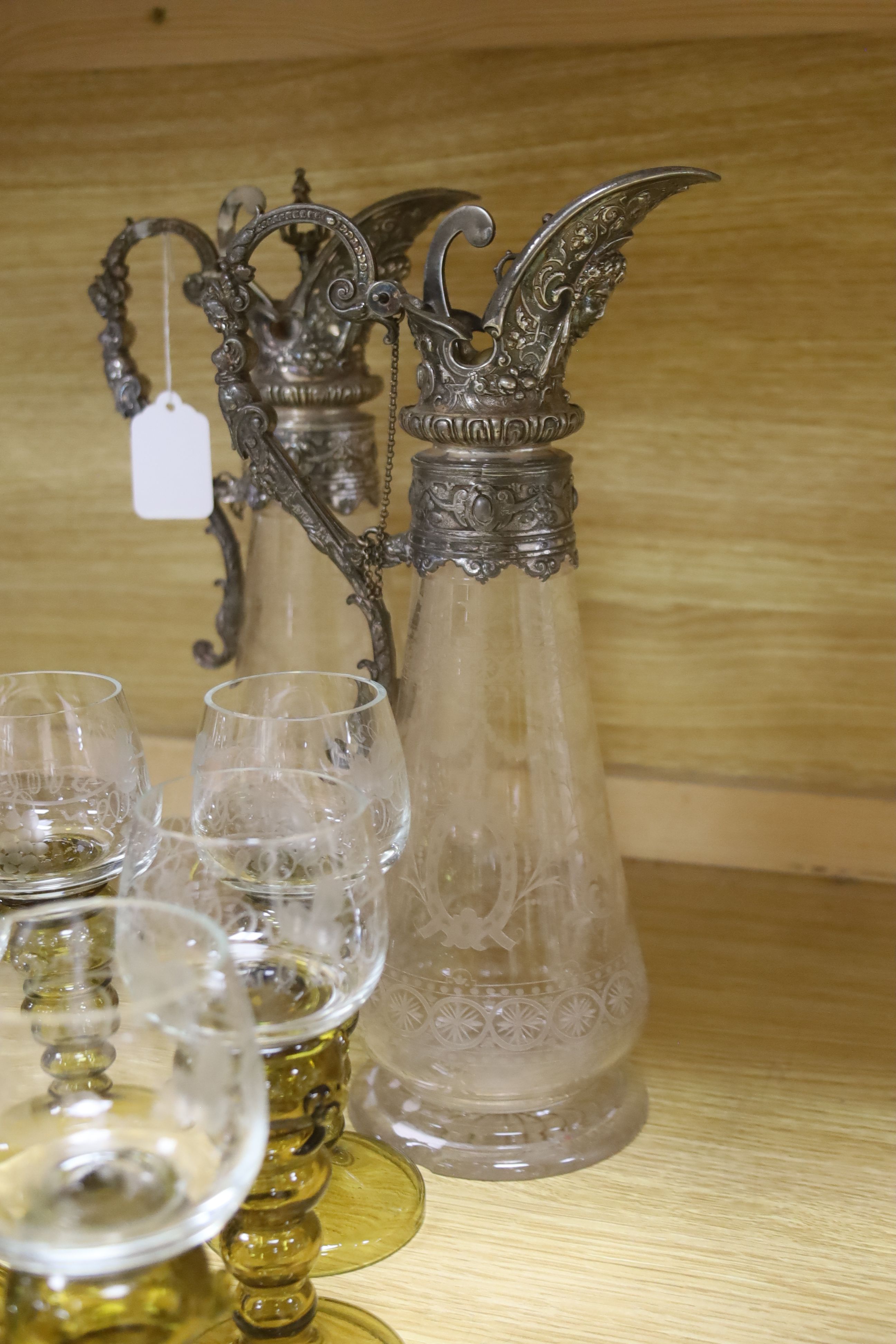 A pair of Victorian claret jugs and a set of eight green hock glasses